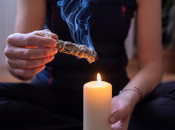 meditating with candle and sage